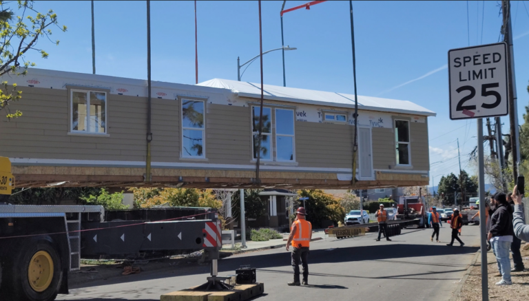 modular home module being lifted by crane during installation in california